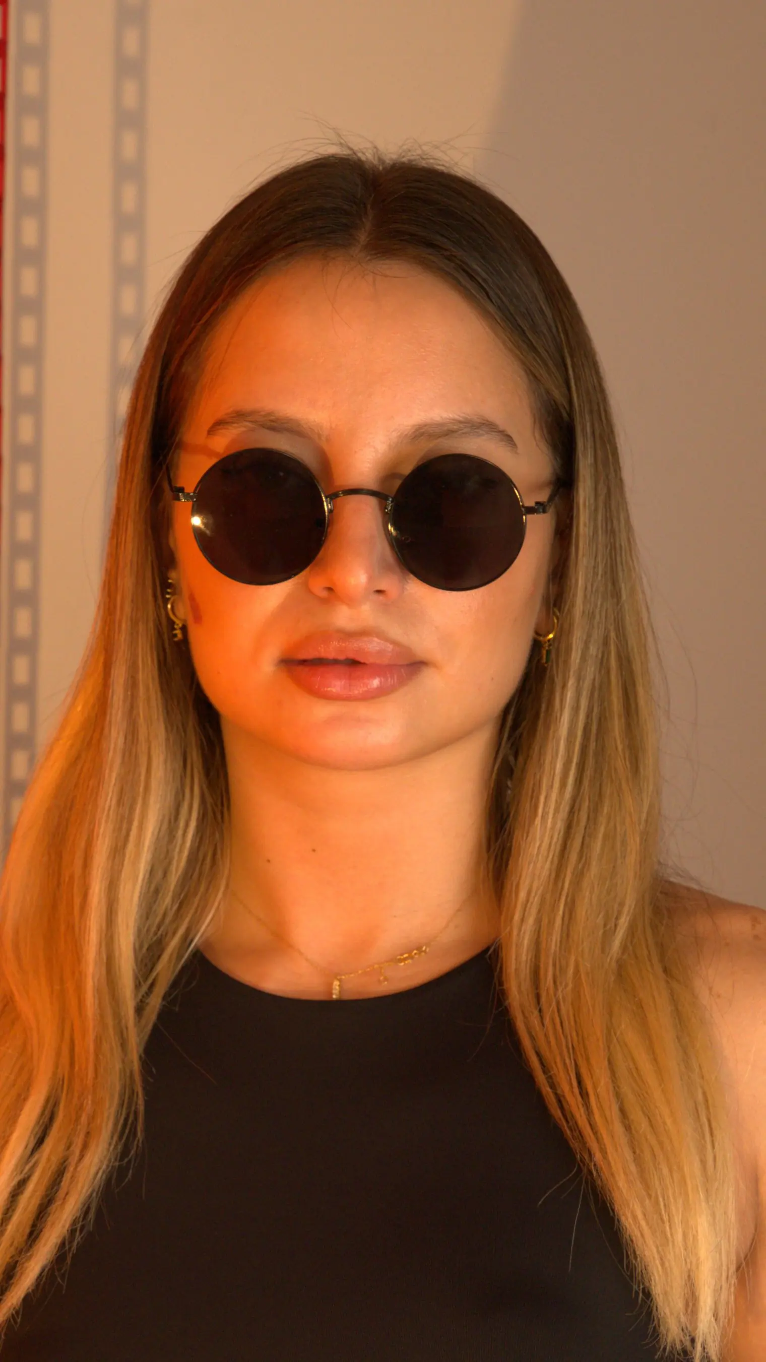 A model wearing EDEN sunglasses in Black